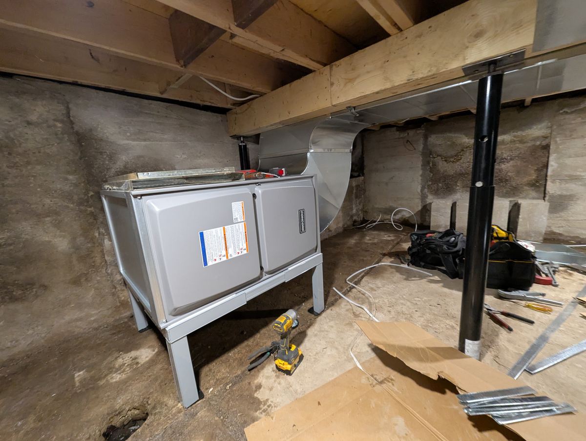 Horizontal furnace installation in progress in a basement